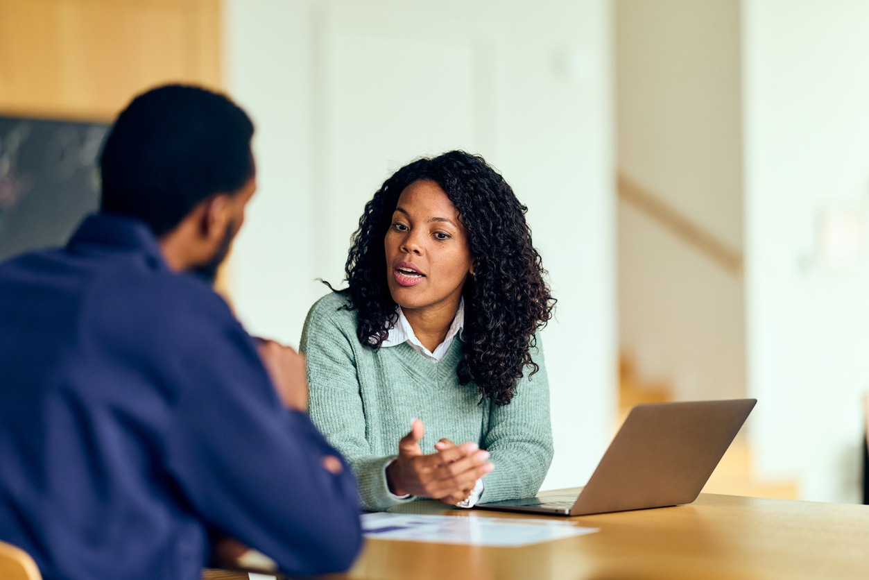 African-American Woman Leads Productive Business Meeting With Colleague at Modern Office Commercial dispute resolution